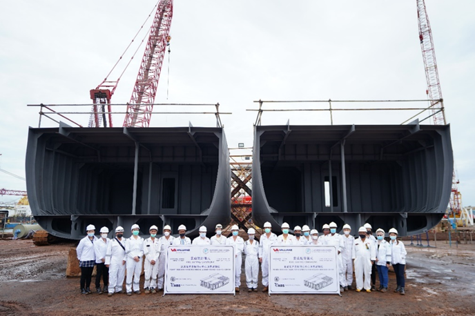 Photo 2. Group photo in front of the new research vessel construction section